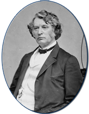  Black and white photograph of Senator Charles Sumner, half-length, seated, left pose in a suit sitting in a chair.