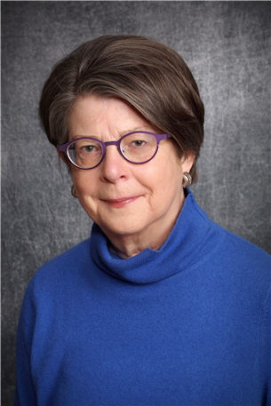 A photograph headshot of a woman (Anne Flitcraft, MD)