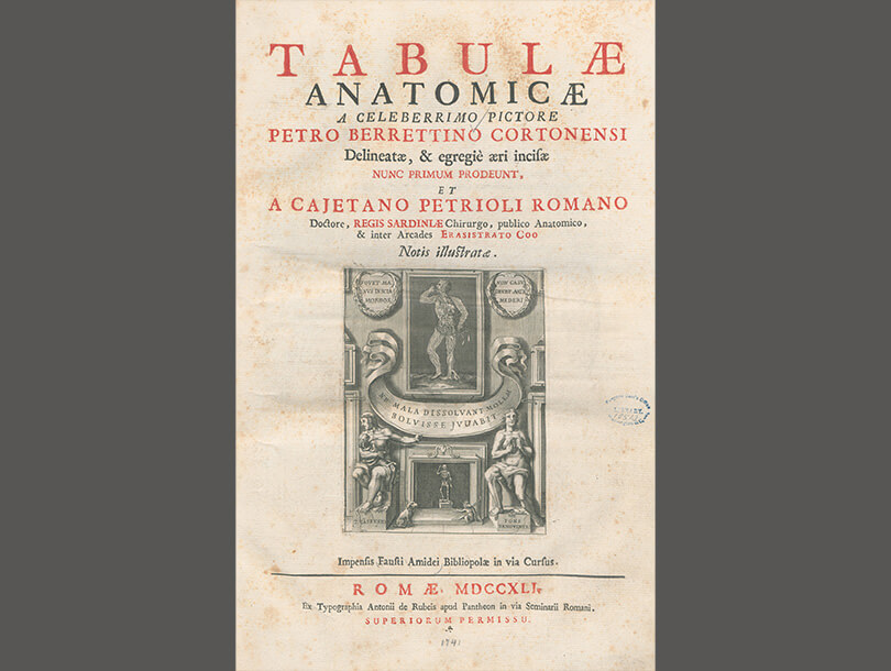 Title page of a book with a fireplace scene on top of which hangs a picture of a dissected man standing and holding some organs on his left hand