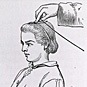 A seated youth, holding a tube and wires, as another person places wires on the youth's head.