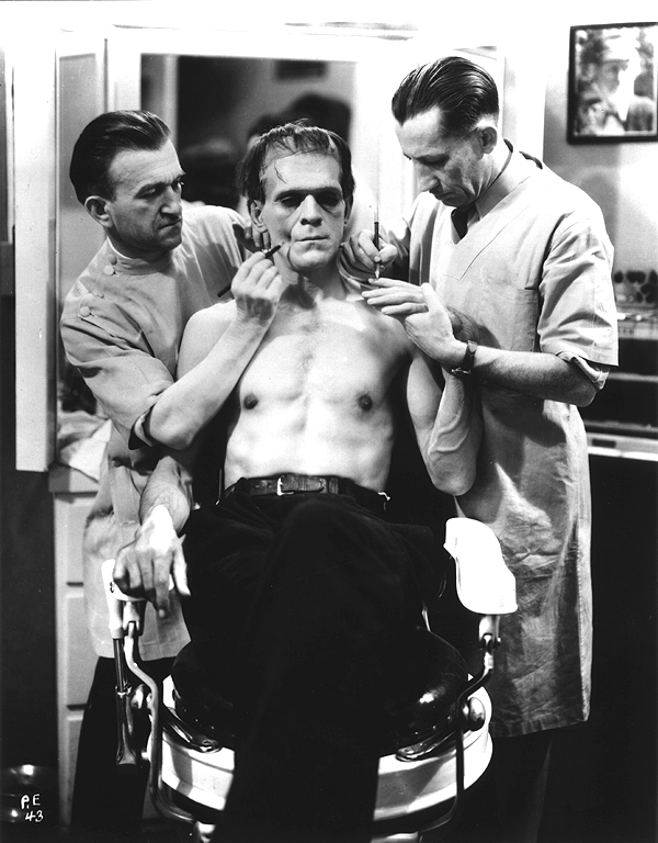 transformed into the Frankenstein Monster by two make-up artist men