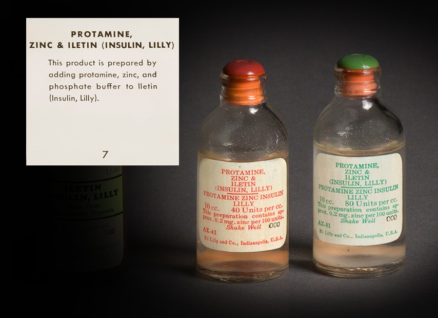 Two, clear glass, sealed bottles with one label with red text and the other with green text.  Both labels read “PROTAMINE, ZINC & ILETIN (INSULIN, Lilly), PROTAMINE ZINC INSULIN LILLY, 10 cc. This preparation contains approx. 0.2 mg. Zinc per 100 units.  Shake Well 000, AX-41 and AX-81, Eli Lilly and Co., Indianapolis, U.S.A.” The red text label notes “40 Unites per cc.” And the green one “80 Units per cc.”