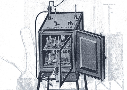 Drawing of an incubator with its door open to show flasks and culture tubes inside.