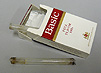 Photograph of a cigarette box with two glass pipes for smoking crack.
