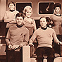 The cast of Star Trek in costume, 6 men and 2 women of various ethnic backgrounds.