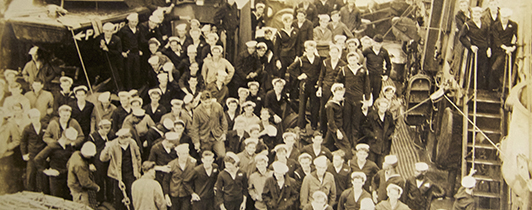 A crowd of sailors on a military vessel.