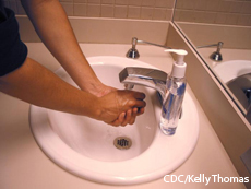 A photograph of a person washing hands with soap