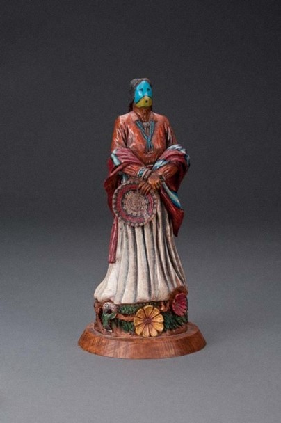 Color image depicting a ceramic statue of a Native American with their face painted blue.