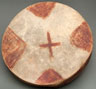 Color image of a round, flat, handmade drum.