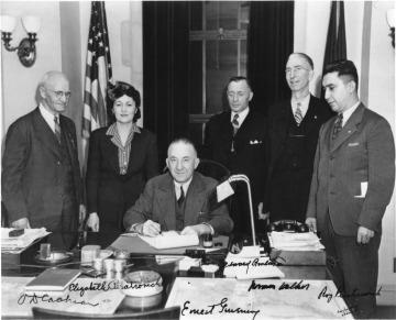 Governor Gruening (Seated) Signs the Anti-Discrimination Act of 1945