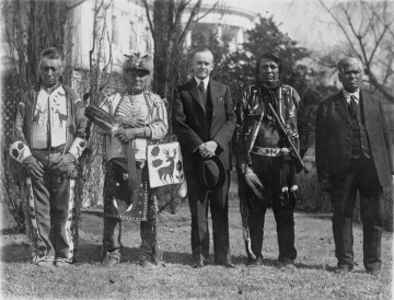 President Calvin Coolidge with four Native Americans at the White House