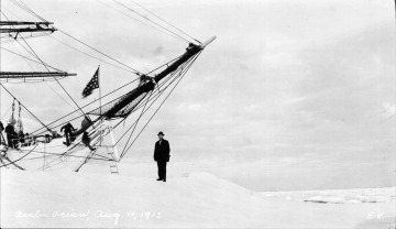 Artic Ocean, Emil Krulish standing outside ship in front of bow