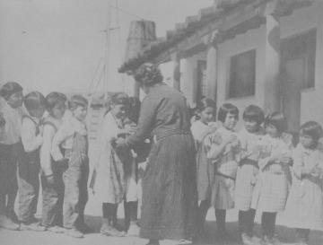 Milk being served to Pueblo children at Isleta Day School, New Mexico