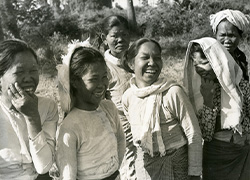Outside, several women stand laughing.
