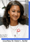 Portrait style image of a woman in white medical coat.  Courtesy Karyn L. Butler, M