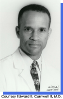 Portrait style image of a man in white medical coat and tie.  Courtesy Edward E. Cornwell, III, M.D.