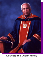 Man seated in academic robes and cap.  Courtesy The Organ Family