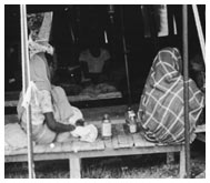 Cholera refugees sit inside tent