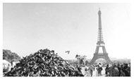 Large pile of shoes in front of Eiffel Tower