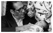 President Jose Napoleon Duarte holds child as other dignataries observe