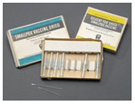 Boxes of dried smallpox vaccine and two bifurcated needles