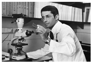 Dr. Anthony Fauci examines sample in his lab