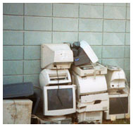 Stack of damaged computers, monitors, and printers
