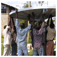 Workers installing satellite dish