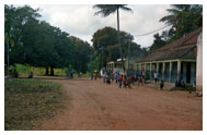 Community members socialize outside of village building