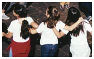 Group of children dance in circle during Agita São Paulo Day