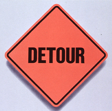 Orange square road sign that says Detour over text