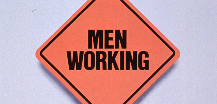 Orange square road sign that says Men Working over text