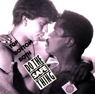 Black and white photograph of a Hispanic man holding a condom and embracing an African American who is slightly lower and looking upwards