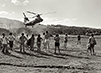 Black and white photograph of a military helicopter descends on a group of occupiers on Kaho‘olawe.