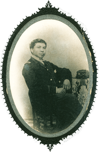 Black and white photograph of William P. Powell, Jr. in a military uniform August 1863, seated with his elbow and hat resting on a table beside him. Courtesy National Archives, Washington, D.C. 