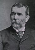 Photographic portrait, in black and white, of Richard Dunglison. Image from chest up of a bearded man in a business suit directly facing the camera with a solemn expression.