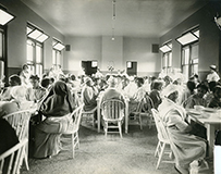Groups of African Americans sitting at several tables