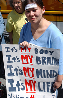 A woman holding a hand–made sign.