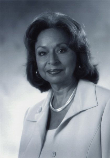 Dr. Vivian W. Pinn, a smiling woman with dark hair in a suit posing for her portrait.