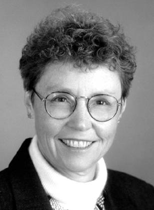 Dr. Carol A. Aschenbrener, a White woman woman with glasses in a dark suit jacket.