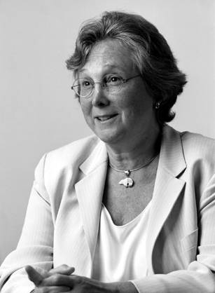 Dr. Mary Margaret Kemeny, a smiling White woman in a light blur suit seated with her hands folded in front of her.