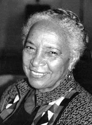 Dr. Maragaret Morgan Lawrence, a smiling African American woman in a patterned top posing for her portrait.