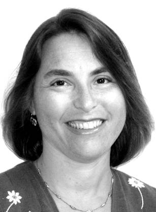 Dr. Jill Nina Afrin, a White woman with cropped hair, smiling at the camera.