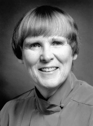 Dr. Barbara Bates, a White woman with short hair smiling for her portrait.