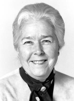 Dr. Marjorie Spurrier Sirridge, a White woman in a scarf, smiling for her portrait.