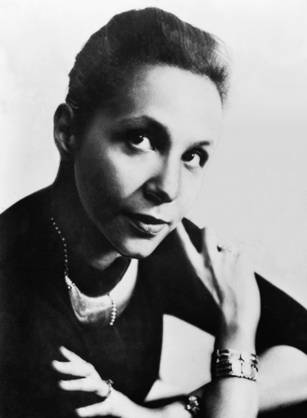 Dr. Jane Cooke Wright, an African American woman in a lab coat and pearls resting her hand on her cheek for her portrait.