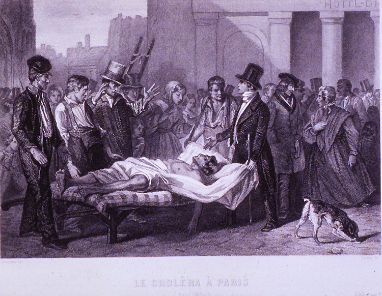 A person laying on a bed surrounded by a group of people.