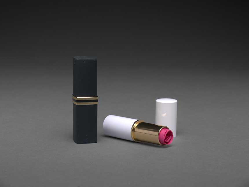 Lipstick case open to show rolled up pink paper inside.