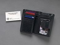A small business card and an opened wallet.