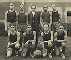 Charles Drew with the rest of the Dunbar High basketball team-- four are kneeling in a front row with a basketball on the ground, and five stands on the back row where Drew is on the left. ca. 1921